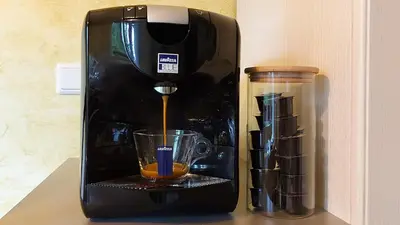 a black coffee maker is sitting on a counter at Apartma Krvavec - cosy mountain retreat in Cerklje na Gorenjskem