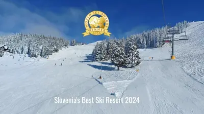 a snow covered slope with a ski resort sign on it at Apartma Krvavec - cosy mountain retreat in Cerklje na Gorenjskem