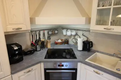 a kitchen with a stove top oven next to a sink at Apartma Krvavec - cosy mountain retreat in Cerklje na Gorenjskem