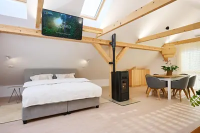 a bedroom with a bed and a tv on the wall at Apartment P42 in Slovenj Gradec