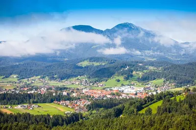a town in the middle of a valley with mountains at Apartment P42 in Slovenj Gradec