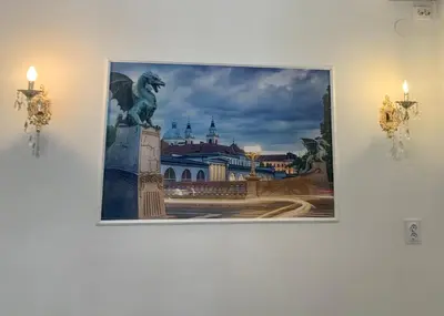 a picture hanging on a wall with a picture of a city at Ljubljana City Center Apartment in Ljubljana