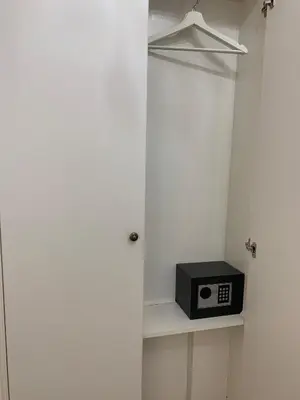 a small black microwave sitting on a shelf in a closet at Ljubljana City Center Apartment in Ljubljana