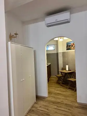 a room with a white cabinet and a table at Ljubljana City Center Apartment in Ljubljana