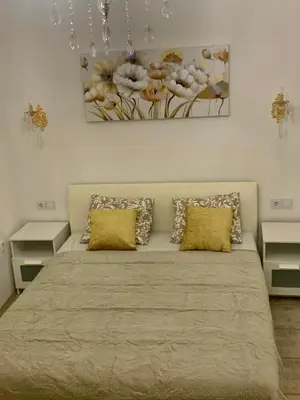 a bedroom with a large bed with yellow pillows at Ljubljana City Center Apartment in Ljubljana