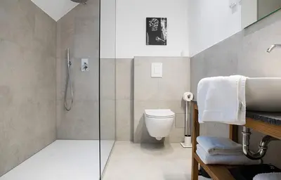 a bathroom with a shower and a toilet and a sink at Hotel Belmur in Murska Sobota