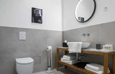 a bathroom with a sink and a toilet and a mirror at Hotel Belmur in Murska Sobota