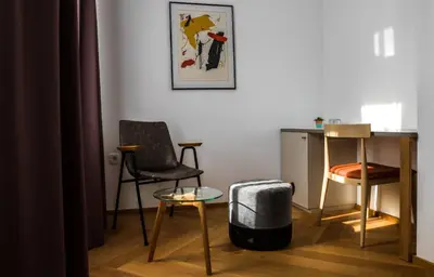a living room with two chairs and a table at Hotel Belmur in Murska Sobota