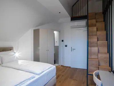 a bedroom with a bed and a sliding glass door at Hotel Belmur in Murska Sobota