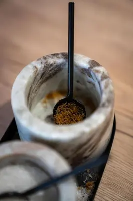 a wooden bowl with a spoon in it at Apartment VAZATAOR with sauna in Brežice