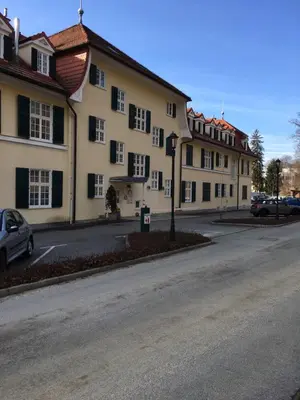 an empty street in front of a large building at Apartment 19 Vila Golf Nice Vacation in Rogaška Slatina