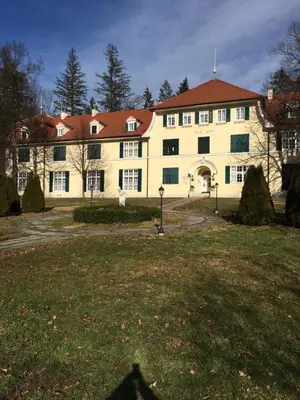a large yellow building with a red roof at Apartment 19 Vila Golf Nice Vacation in Rogaška Slatina