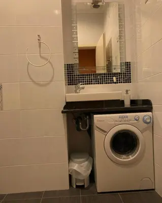 a bathroom with a washing machine and a sink at Apartment 19 Vila Golf Nice Vacation in Rogaška Slatina