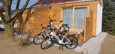 two bikes parked in front of a wooden house at Apartma, glamping Na koncu vasi in Ljutomer