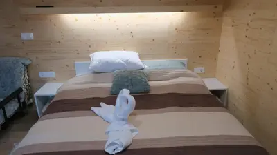 a bedroom with a bed with a white animal on it at Apartma, glamping Na koncu vasi in Ljutomer