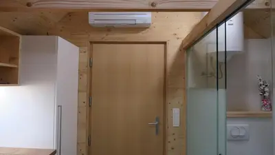 a door in a room with a wooden wall at Apartma, glamping Na koncu vasi in Ljutomer