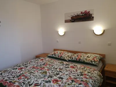 a bedroom with a bed and two pillows on it at Apartma TiJa in Moravske Toplice