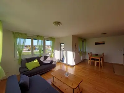 a living room with a couch and a table at Apartma TiJa in Moravske Toplice