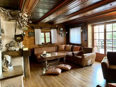 a living room with a couch and a table at Mountain Dreams House - Stunning view over Lake Jasna! in Kranjska Gora
