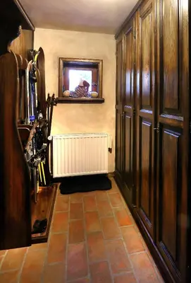 a hallway with a room with wooden cabinets and a mirror at Mountain Dreams House - Stunning view over Lake Jasna! in Kranjska Gora