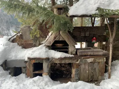 a snow covered outdoor oven with snow on it at Mountain Dreams House - Stunning view over Lake Jasna! in Kranjska Gora
