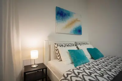 a bedroom with a bed and a painting on the wall at APARTMENT SAPICA in Solkan