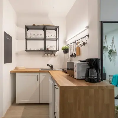 a kitchen with white cabinets and a counter top at APARTMENT SAPICA in Solkan