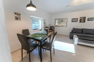 a dining room and living room with a table and chairs at Nature Lover's Paradise in Julian Alps in Mojstrana