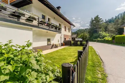 a house with a fence next to a road at Nature Lover's Paradise in Julian Alps in Mojstrana