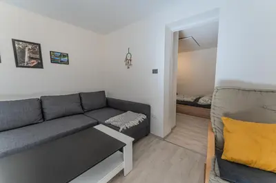a living room with a couch and a bedroom at Nature Lover's Paradise in Julian Alps in Mojstrana