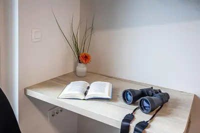 a table with a book and a camera on it at Apartmaji Pr Smolet in Škofja Loka