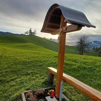 a bird house in a field with a castle in the background at Apartmaji Pr Smolet in Škofja Loka