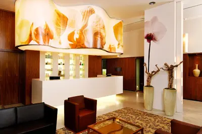 a lobby of a hotel with a large chandelier at Hotel Toplice - Terme Krka in Smarjeske Toplice