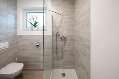 a bathroom with a shower and a toilet at Gostilna Pugelj in Novo Mesto