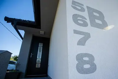 a house with a sale sign on the side of it at Gostilna Pugelj in Novo Mesto