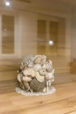 a vase filled with shells sitting on a table at Apartma Jelendol in Tržič