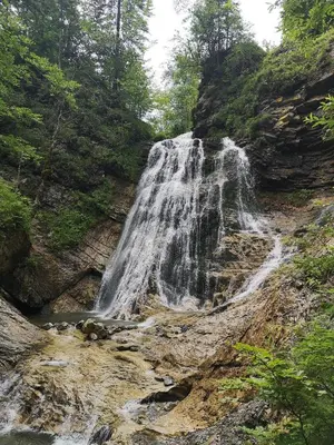 a waterfall on the side of a rocky mountain at Apartma Jelendol in Tržič