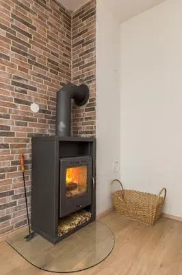 a fireplace in a room with a brick wall at Apartma Jelendol in Tržič