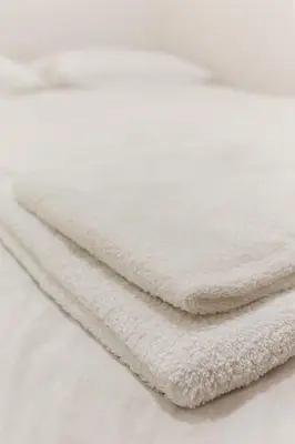 a pile of white towels sitting on a table at Apartma Jelendol in Tržič