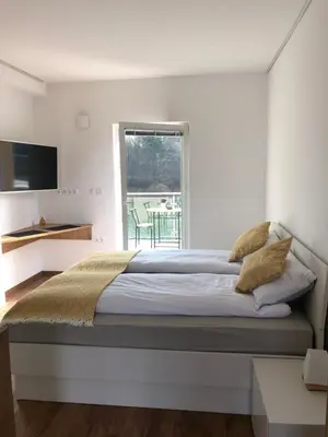 a bedroom with a large bed and a window at Maximo Apartments - free parking in Maribor