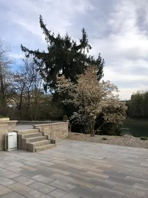a park with stairs and a tree and water at Maximo Apartments - free parking in Maribor
