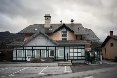 a large house with a black and white at Duplex Apartment Panj Kranjska Gora in Kranjska Gora