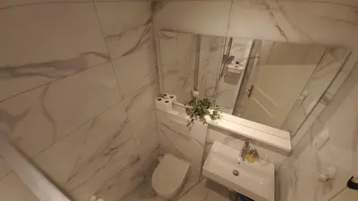 a white bathroom with a sink and a mirror at Duplex Apartment Panj Kranjska Gora in Kranjska Gora