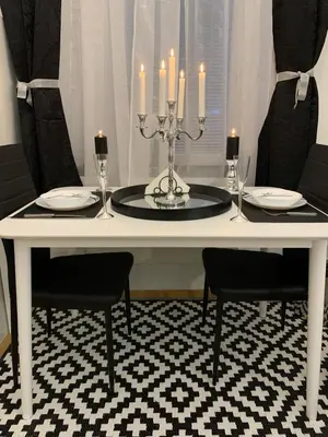 a white table with candles and plates and chairs at Apartment Capital in Maribor