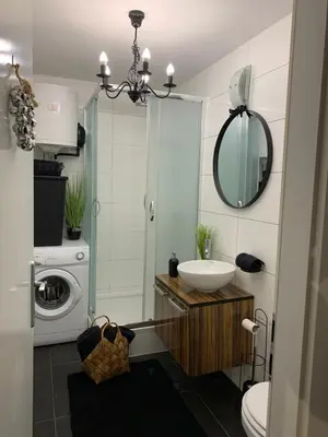 a bathroom with a sink and a washing machine at Apartment Capital in Maribor
