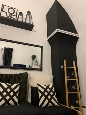 a black room with a mirror and a couch at Apartment Capital in Maribor