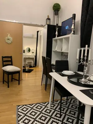 a dining room and living room with a table and chairs at Apartment Capital in Maribor