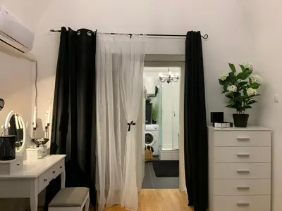 a bathroom with a black and white shower curtain at Apartment Capital in Maribor