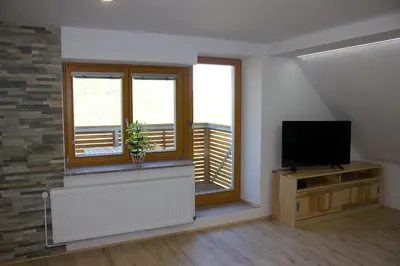a living room with a tv and a window at Malina in Vransko