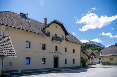 a large white building with a sign on it at BonAire apartment in Kranjska Gora
